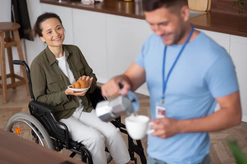 Caring support worker sharing a warm moment with an NDIS participant during a respite care session in Joondalup, Western Australia